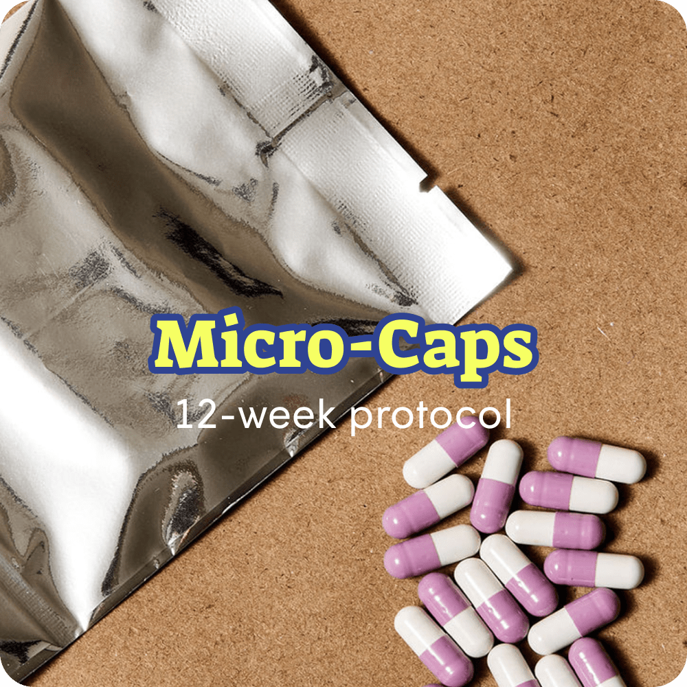 Purple and white capsules on a cork board with 'Micro-Caps 12-week protocol' text.