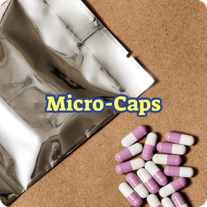 Purple and white capsules on a cork board with 'Micro-Caps' text overlay.