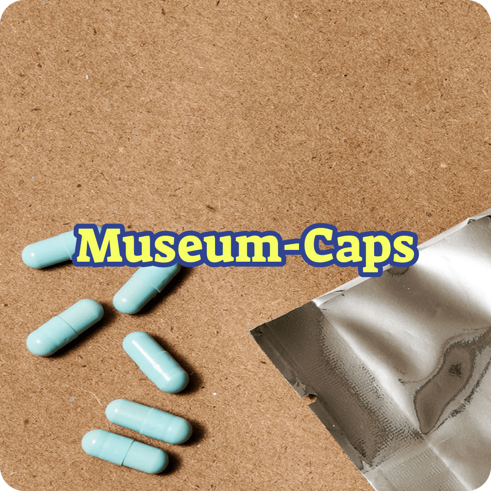 Blue capsules on a brown surface with 'Museum-Caps' text overlay.